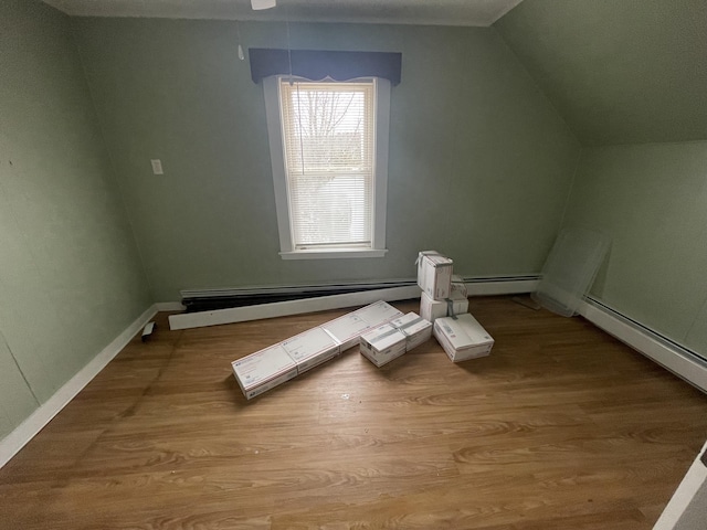 bonus room featuring lofted ceiling, light hardwood / wood-style floors, and baseboard heating