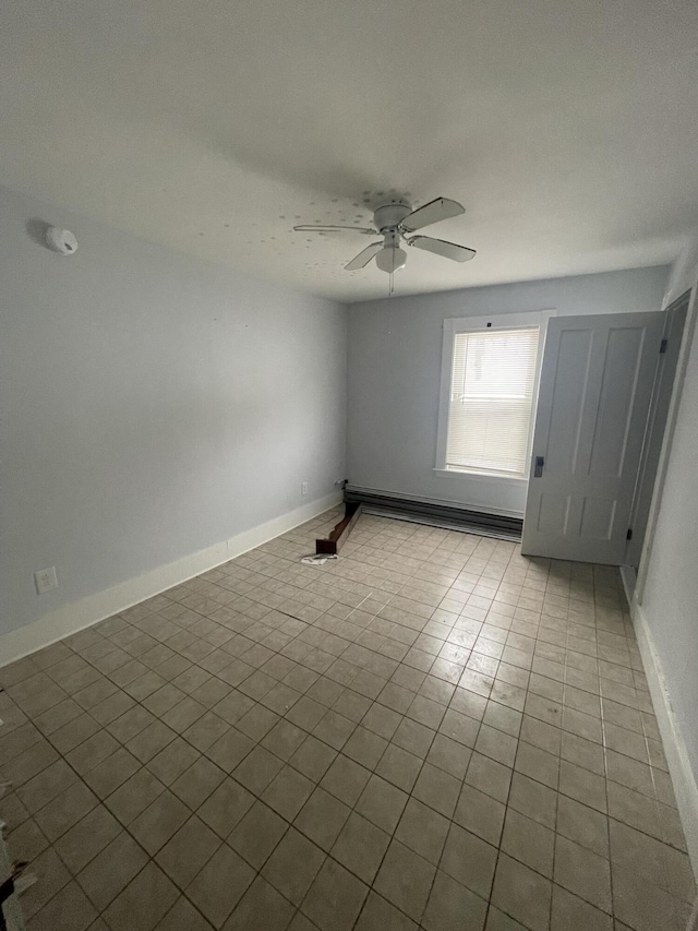 empty room with a baseboard heating unit and ceiling fan