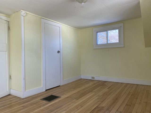 unfurnished bedroom featuring a closet and light wood-type flooring