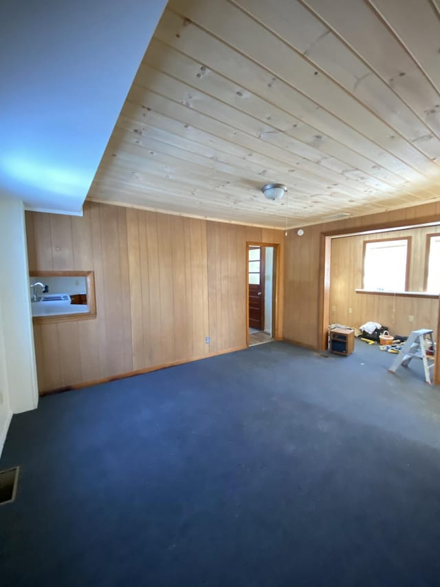 interior space with wood ceiling and wood walls