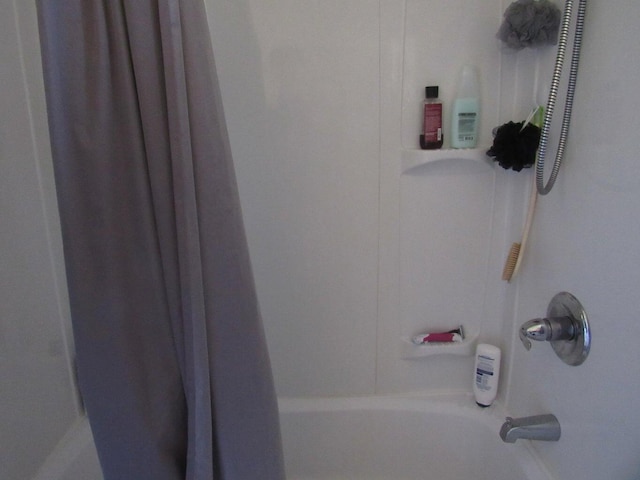 bathroom with shower / bath combination with curtain