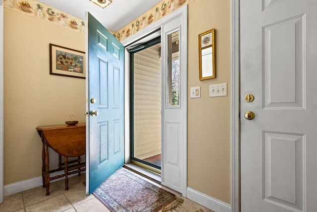 doorway featuring baseboards and light tile patterned floors