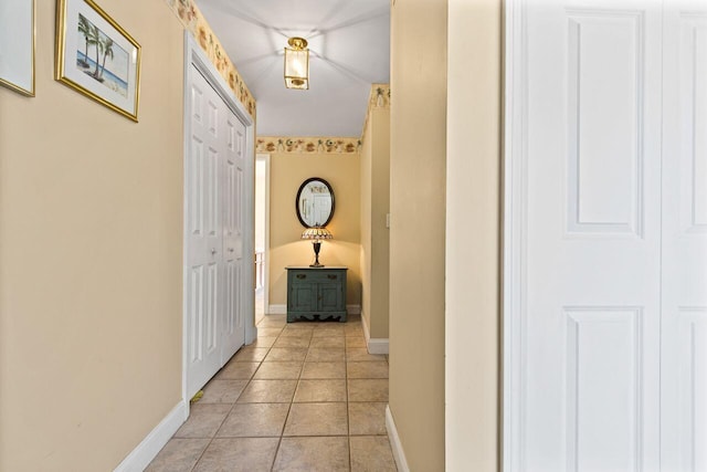 hallway with baseboards and light tile patterned floors