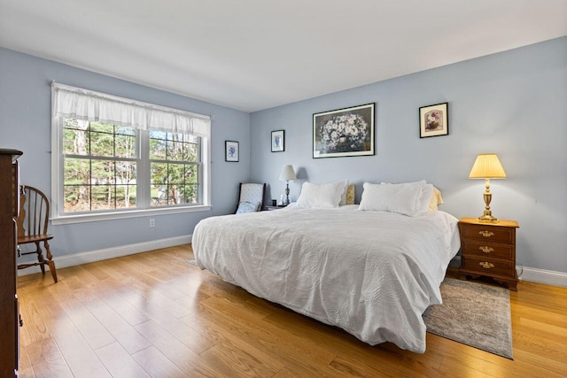 bedroom featuring baseboards and wood finished floors