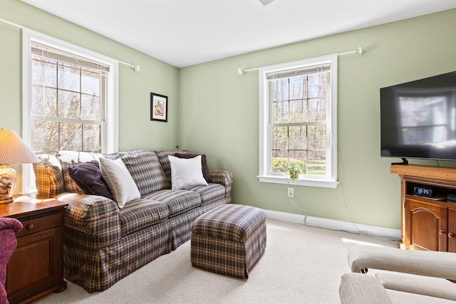 carpeted living room with baseboards