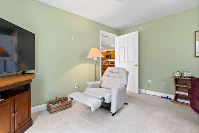 living area featuring baseboards and carpet flooring