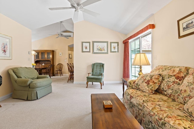 living area featuring carpet floors, a ceiling fan, baseboards, and vaulted ceiling