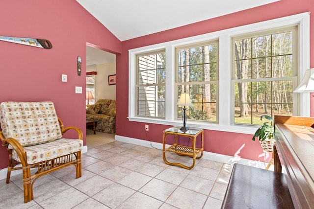 sitting room featuring light tile patterned flooring, a wealth of natural light, and lofted ceiling