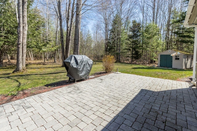 view of patio with a storage shed, an outdoor structure, and area for grilling