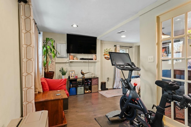 workout room with wood finished floors, visible vents, and recessed lighting