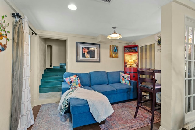 living room with recessed lighting, stairway, and wood finished floors