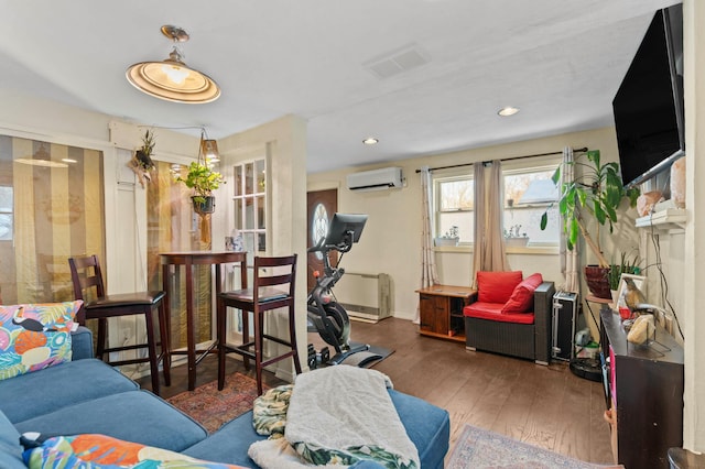 living area featuring recessed lighting, visible vents, baseboards, hardwood / wood-style floors, and a wall mounted air conditioner