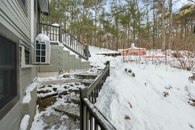 snowy yard featuring stairs