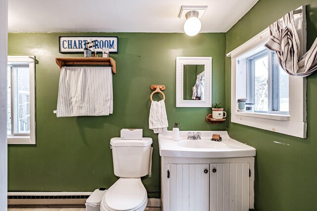 bathroom with baseboard heating, vanity, and toilet