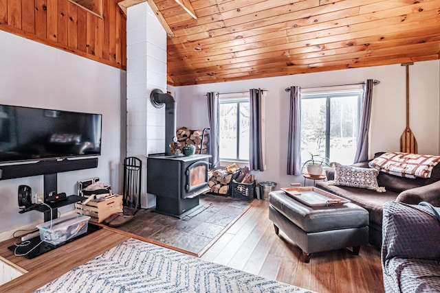 living room with vaulted ceiling, a wood stove, hardwood / wood-style floors, and wood ceiling