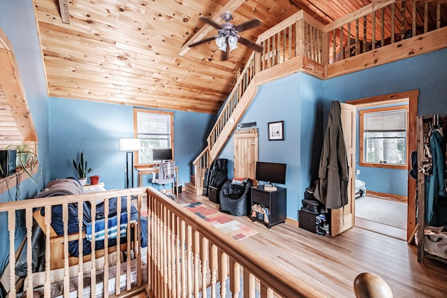 bedroom with hardwood / wood-style flooring, vaulted ceiling with beams, and wooden ceiling