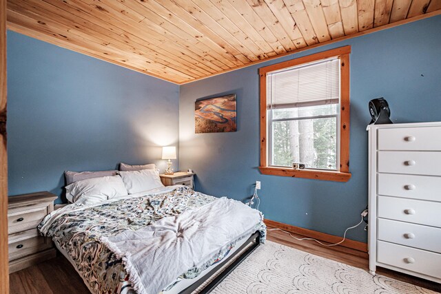 bedroom with wood ceiling and light hardwood / wood-style flooring