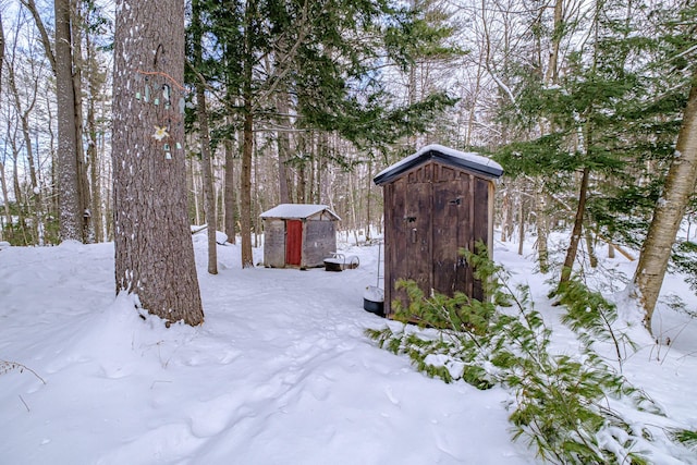 snowy yard with a shed