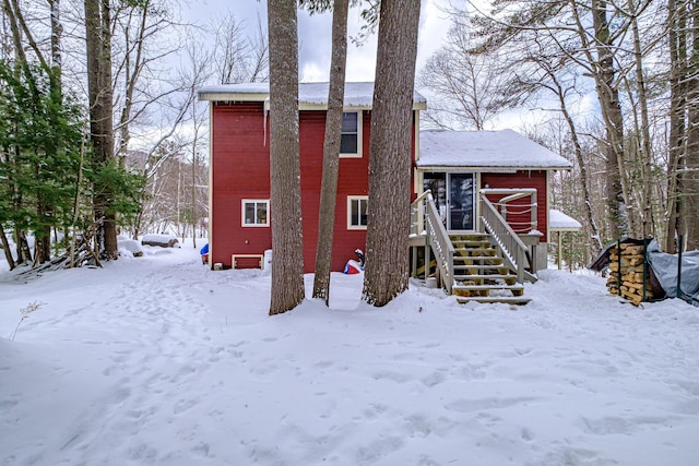 view of snow covered back of property