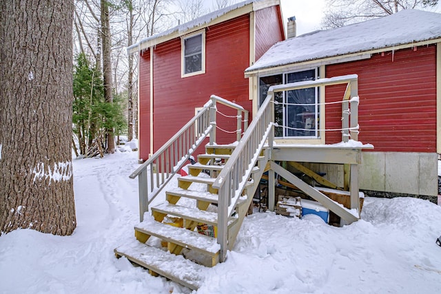 view of snow covered property entrance