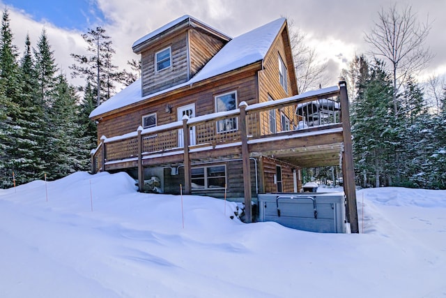 view of front of home with a hot tub and a deck