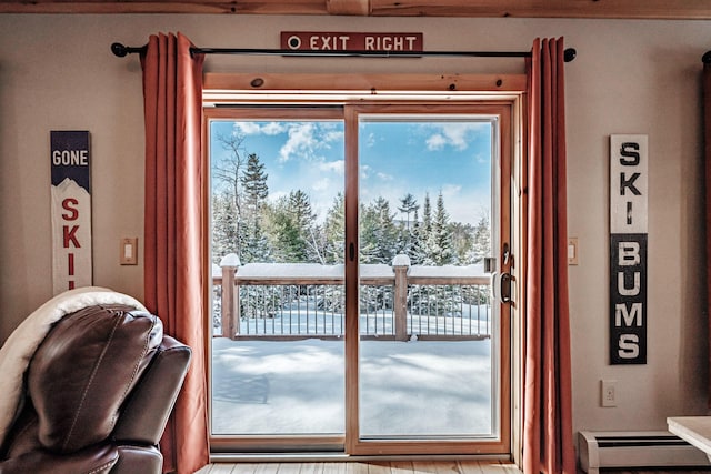 doorway featuring a baseboard heating unit and a wealth of natural light