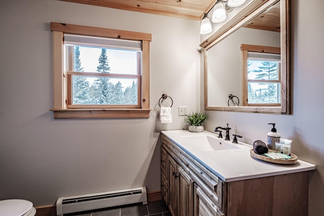 bathroom with vanity, tile patterned floors, baseboard heating, and toilet