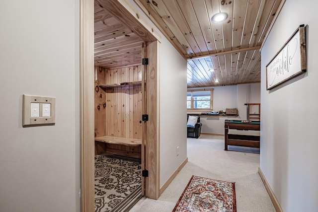 corridor featuring wood ceiling and light carpet