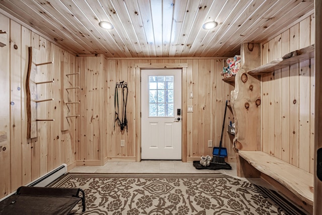 mudroom featuring a baseboard heating unit, wood ceiling, and wooden walls