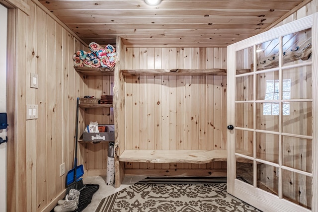 mudroom with wooden walls and wooden ceiling