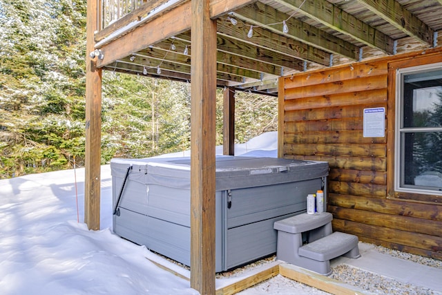 wooden deck with a hot tub