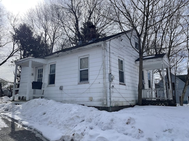 bungalow-style house featuring a porch and a chimney