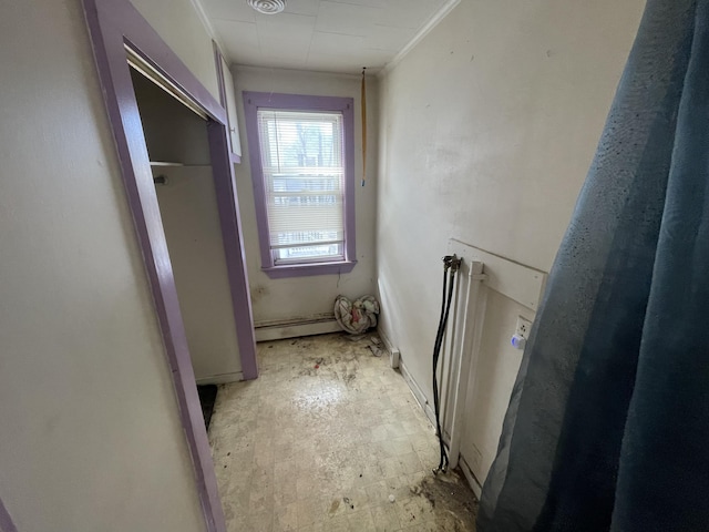 hallway featuring crown molding and baseboard heating