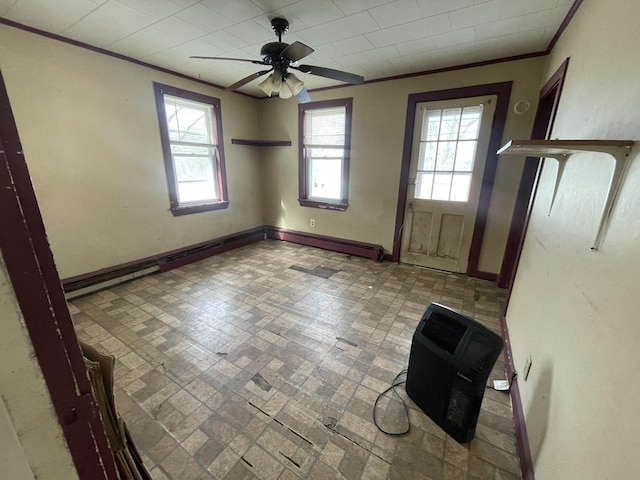 foyer entrance with ceiling fan, ornamental molding, and baseboards