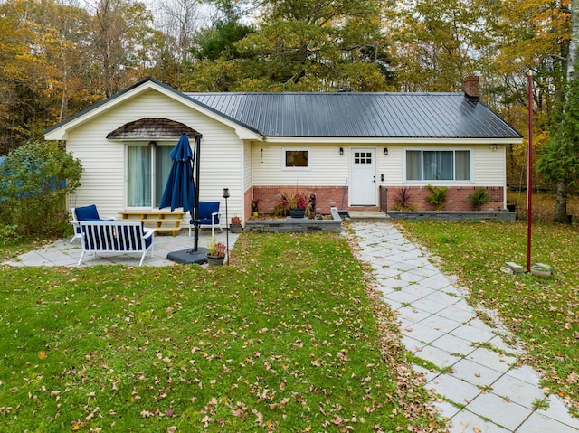 exterior space featuring a patio area and a front lawn