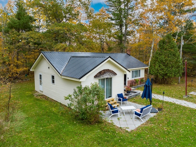 back of property with a patio and a lawn