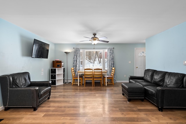 living room with a baseboard radiator, hardwood / wood-style floors, and ceiling fan