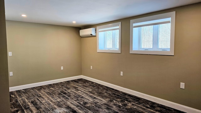 interior space featuring recessed lighting, baseboards, wood finished floors, and a wall mounted air conditioner