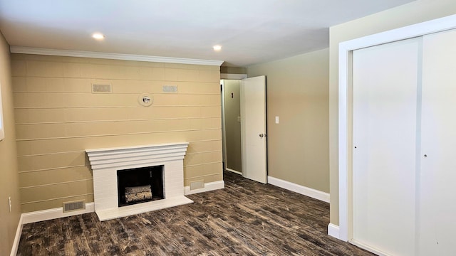 unfurnished living room featuring recessed lighting, visible vents, dark wood-type flooring, a brick fireplace, and baseboards