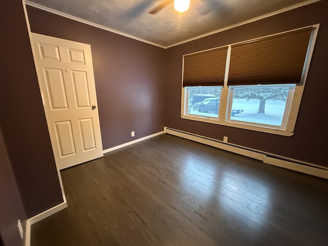 spare room featuring crown molding, ceiling fan, dark hardwood / wood-style flooring, and a baseboard radiator