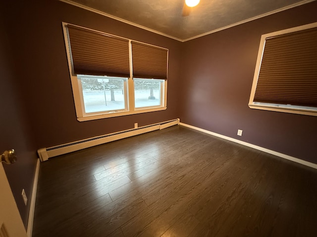 unfurnished room featuring a baseboard heating unit, crown molding, and dark wood-type flooring