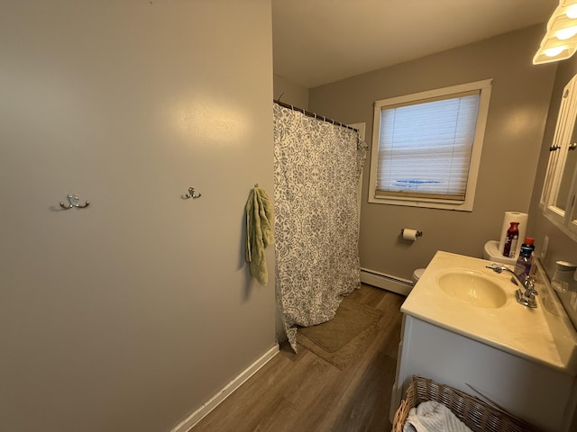 bathroom with baseboard heating, vanity, toilet, and hardwood / wood-style flooring