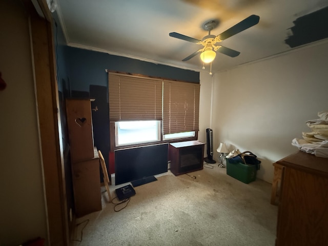 unfurnished bedroom featuring ceiling fan, ornamental molding, and light colored carpet