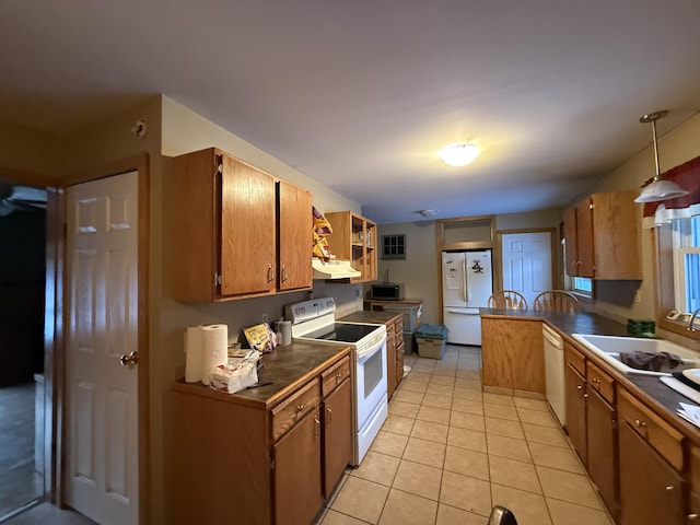 kitchen featuring light tile patterned flooring, white appliances, decorative light fixtures, and sink