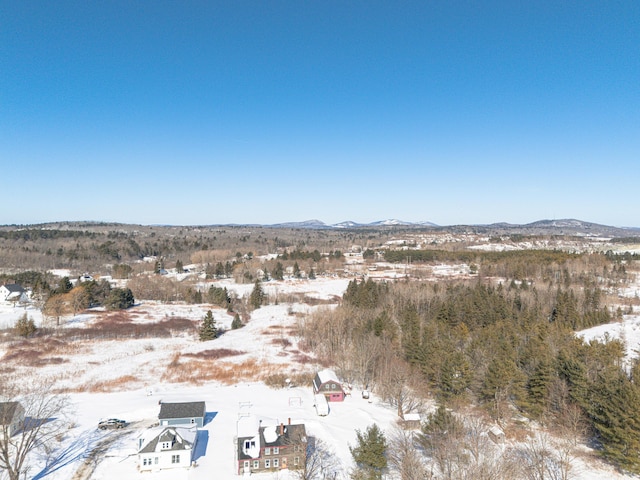 snowy aerial view featuring a mountain view