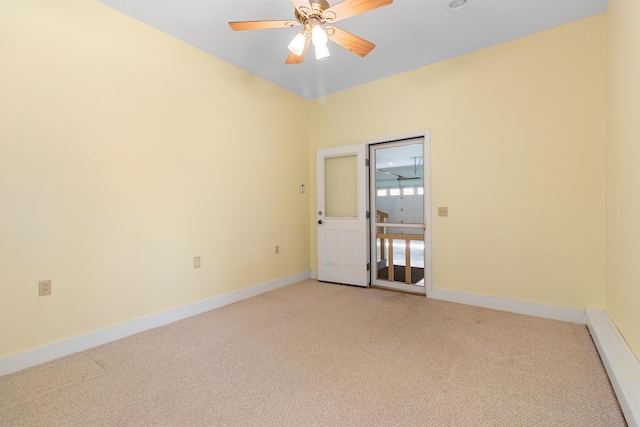 empty room with baseboards, a ceiling fan, and light colored carpet