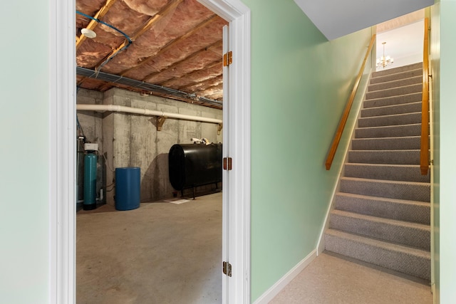 stairs featuring heating fuel, concrete floors, and baseboards