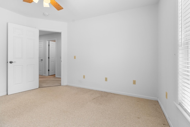 unfurnished bedroom with carpet, baseboards, and a ceiling fan