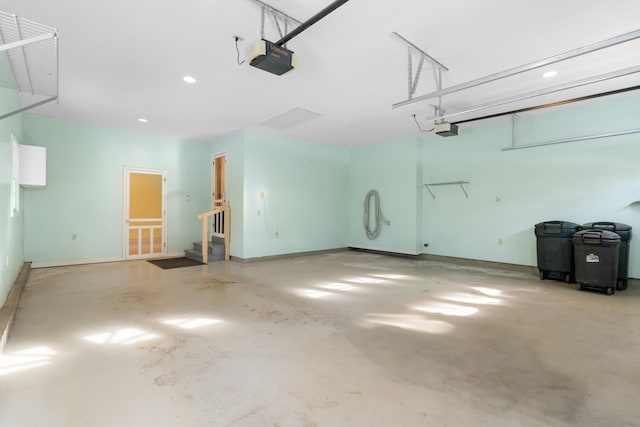 garage with baseboards and a garage door opener