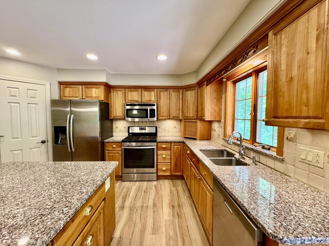 18 Patricia Ln, Saint George, ME 04859 - kitchen featuring stainless steel appliances, a sink, light stone countertops, brown cabinetry, and recessed lighting